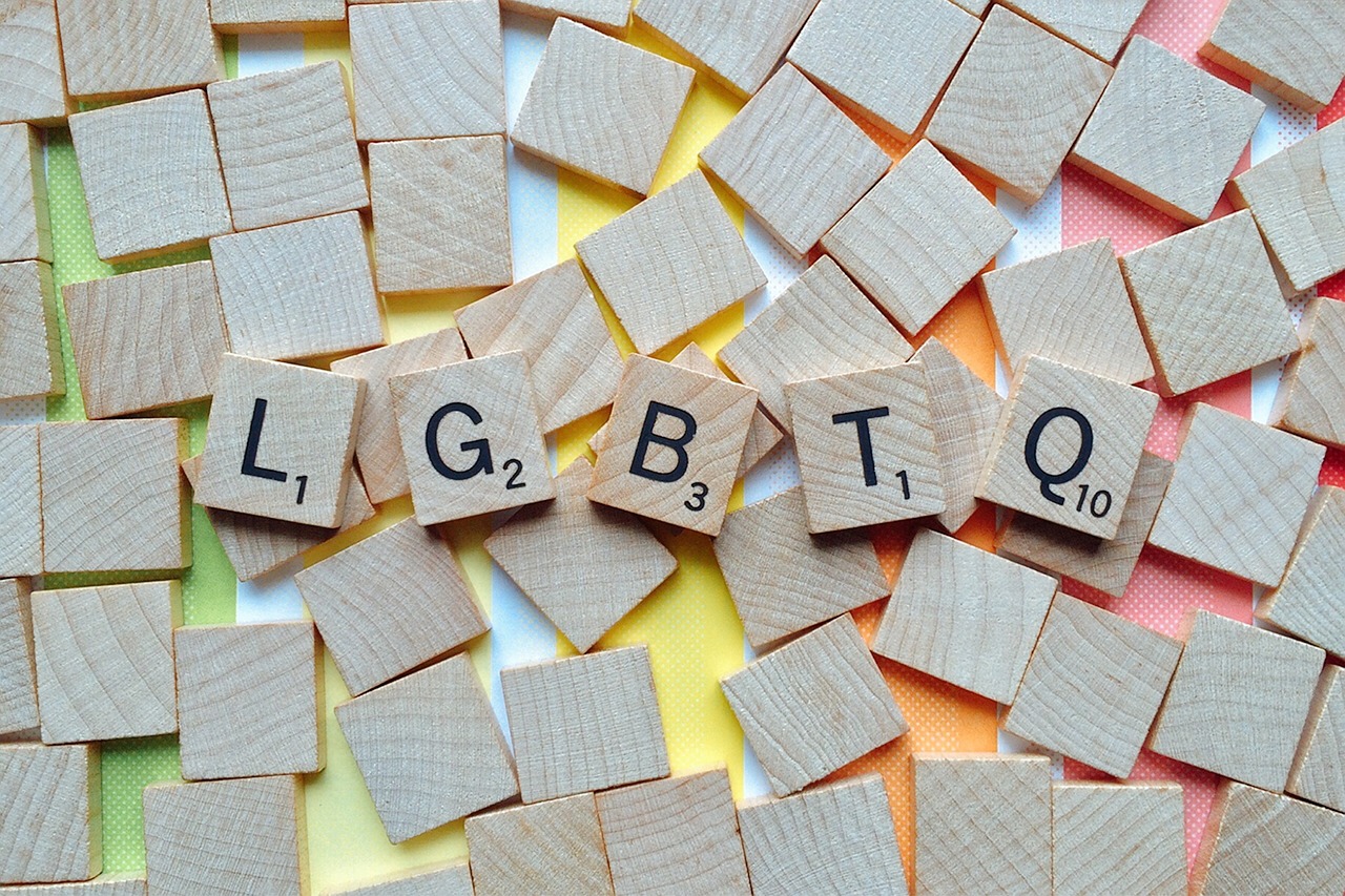 Scattered tiles spelling out LGBTQ